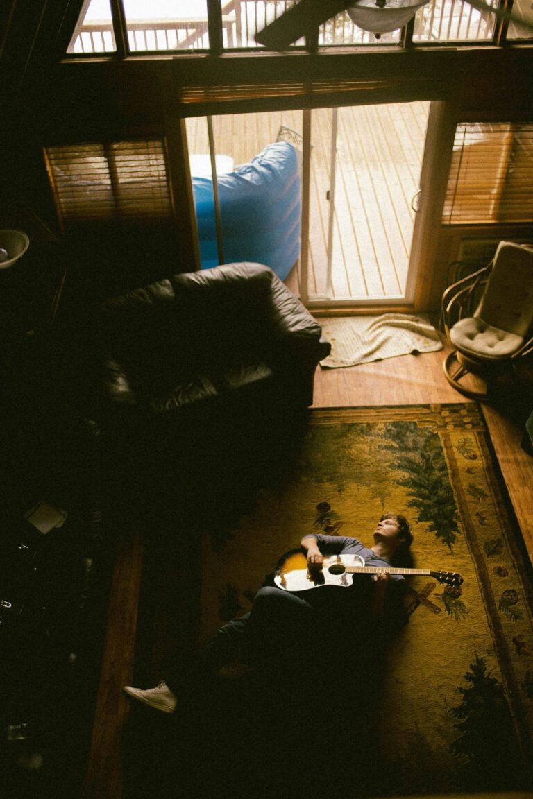 someone playing guitar in the sunlight after gardening